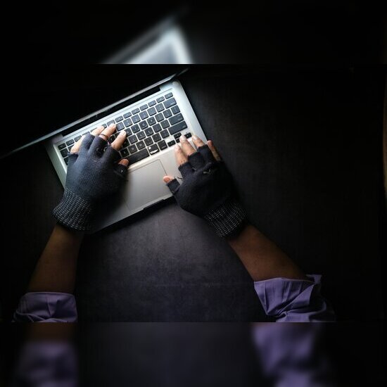 a computer hacker typing on a keyboard