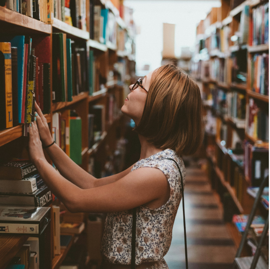 A girl looking at books in a library