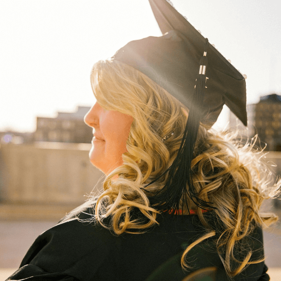 Woman in mortar board with sun shining