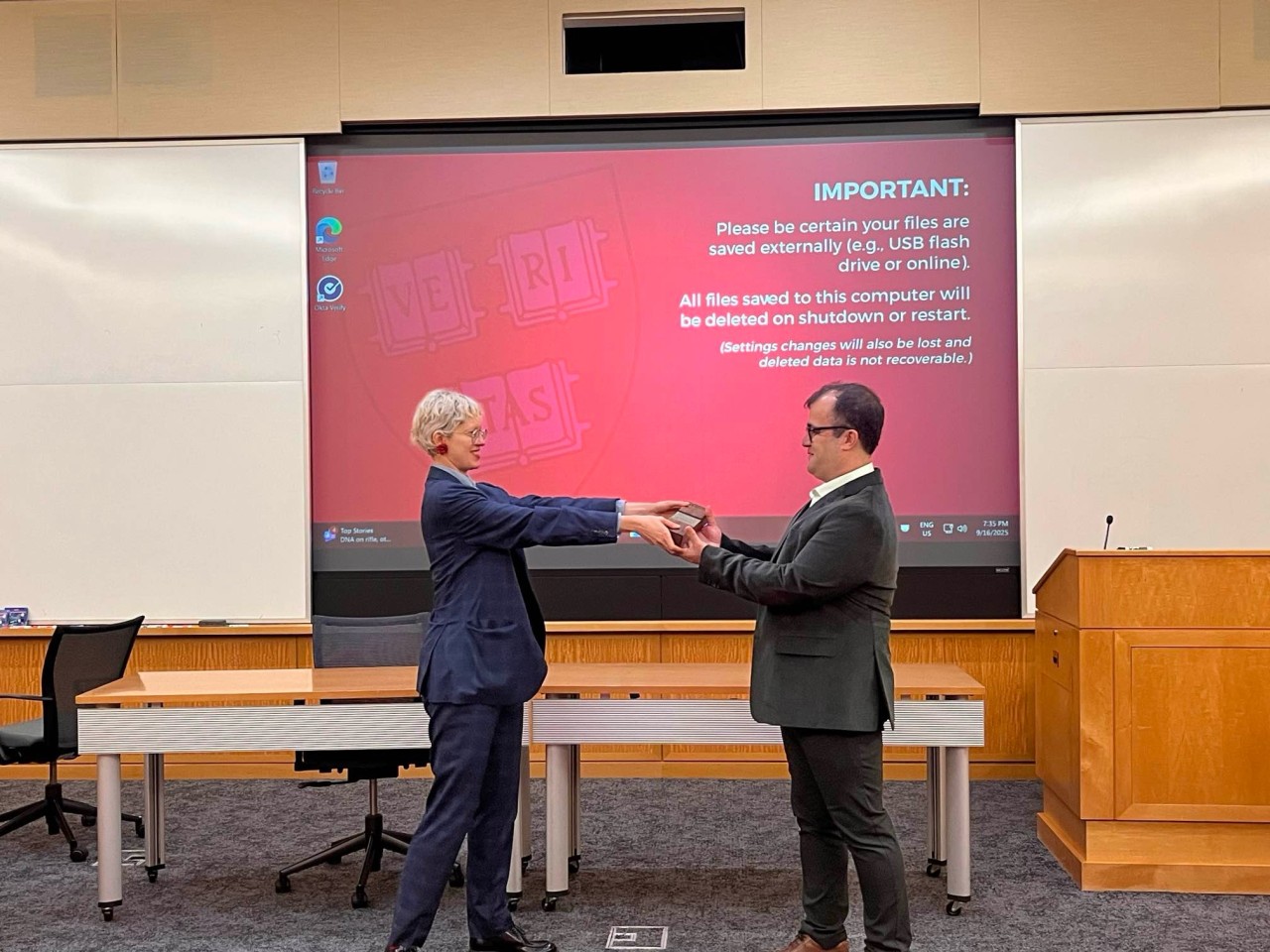 Aline Bessa from KNIME’s Educators Alliance hands the KNIME Distinguished Award trophy to Professor Ahady Dolatsara.