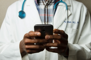Image of doctor texting on his phone