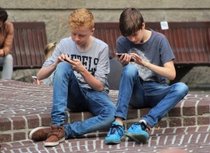 Image of boys using phones