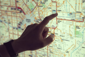 A hand pointing at a city map